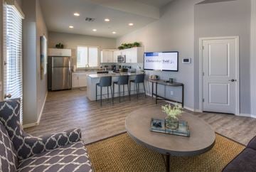 Goodyear apartment for rent - A modern living room with a grey sofa and a coffee table.