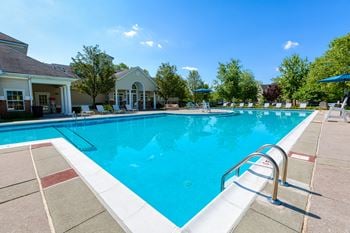 Swimming pool with clubhouse behind it