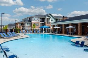 Murfreesboro apartment for rent - our apartments offer a large swimming pool with chairs and umbrellas at Annandale Apartment Homes, Murfreesboro, TN