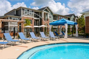 Blue pool loungers and private cabana on pool deck