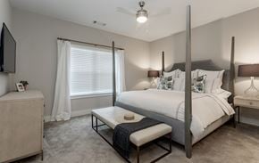 Murfreesboro apartment for rent - a bedroom with a bed and a table in front of a window at Annandale Apartment Homes, Murfreesboro, 37128