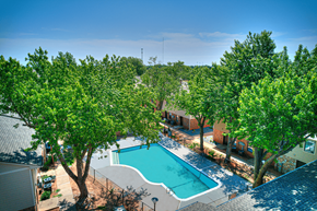 Norman townhouse for rent - an aerial view of a swimming pool with trees and a resort style pool at Diamond Crest Townhomes, Norman, OK 73071