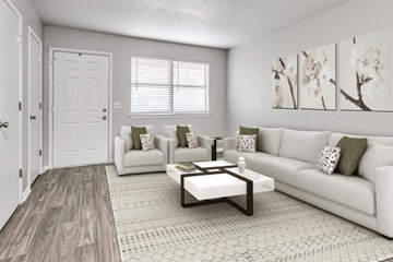 Oklahoma City apartment for rent - A living room with a white couch, a coffee table, and a painting on the wall.