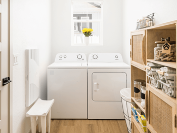 A small laundry room with a washing machine and a washer and dryer