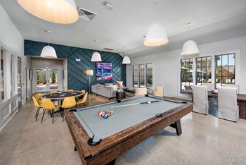A game room with a pool table and a television