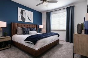 South Daytona apartment for rent - A bedroom with a large bed and a ceiling fan at Enclave at 3230 Apartments, South Daytona, Florida