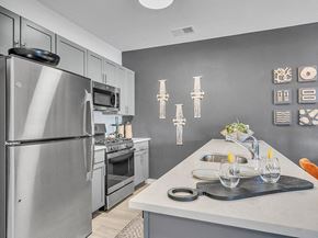 Union  Twp apartment for rent - A modern kitchen with a stainless steel refrigerator and a white countertop.