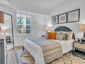 Union  Twp apartment for rent - A bedroom with a large bed and a window overlooking a tree.