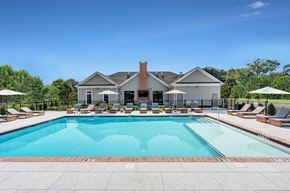 Union  Twp apartment for rent - A large swimming pool surrounded by lounge chairs and umbrellas.
