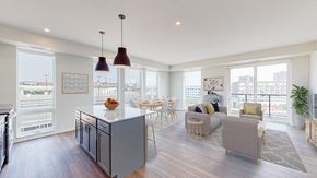 St. Paul apartment for rent - A modern kitchen with a dining table and chairs. at The Arlow on Kellogg, St. Paul, MN