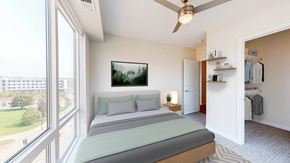 St. Paul apartment for rent - A bedroom with a large bed and a ceiling fan. at The Arlow on Kellogg, Minnesota