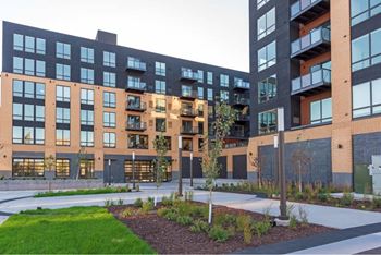 A modern building with a courtyard in front.