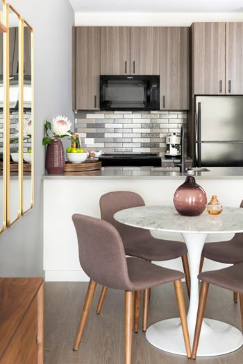 Compact kitchen with mixed tile backsplash and modern finishes
