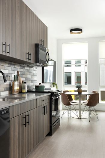 Modern kitchen with wood cabinetry and dining space