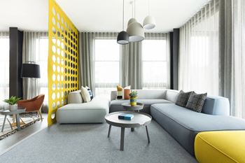 Modern living room with yellow partition and sectional sofa