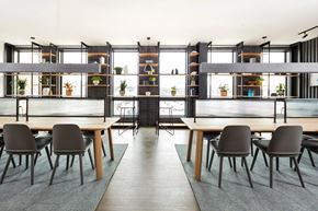 Jersey City apartment for rent - Coworking area with wood tables and industrial shelving at 295J Apartments, Jersey City