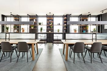 Coworking space with wood tables and shelving