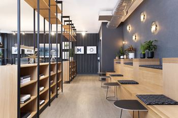 Coworking lounge with tiered bench seating and decorative lighting