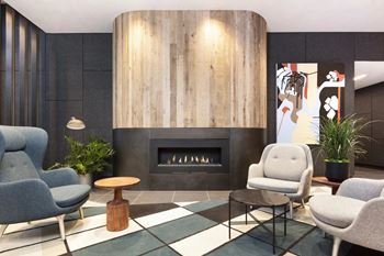 Resident lounge with fireplace and modern seating