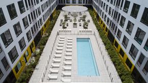 Jersey City apartment for rent - Courtyard pool deck with lounge chairs and landscaping at 295J Apartments, Jersey City