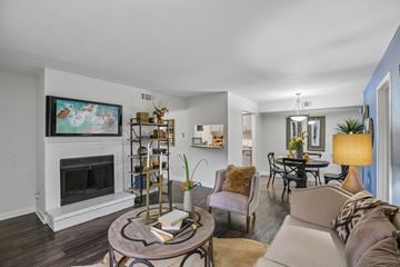 Houston apartment for rent - A living room with a fireplace and a painting on the wall.