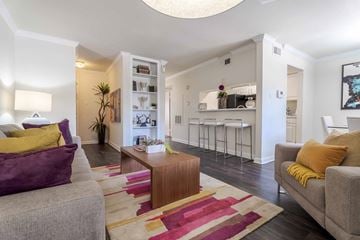 Houston apartment for rent - A living room with a grey couch and a wooden coffee table.