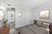 Tucson apartment for rent - A bedroom with a large bed and a painting on the wall.
