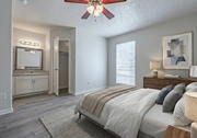 Bryan apartment for rent - A bedroom with a large bed and a ceiling fan.