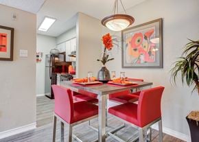 College Station apartment for rent - Dining area with a table and chairs and a kitchen in the background at Sausalito Apartments, Texas