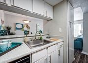 College Station apartment for rent - a kitchen with white cabinets and a stainless steel sink at Sundance Apartments, College Station, Texas