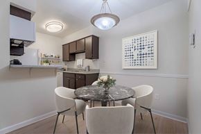 Houston apartment for rent - A kitchen with a table and chairs in the foreground.