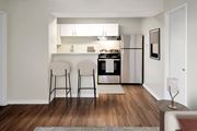 College Station apartment for rent - A kitchen with a refrigerator, oven, and sink is visible.
