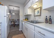 Bryan apartment for rent - Kitchen with white cabinets and a stainless steel sink  at Willow Oaks, Texas, 77802