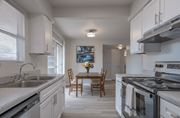 Bryan apartment for rent - A kitchen with a table and chairs in the middle.