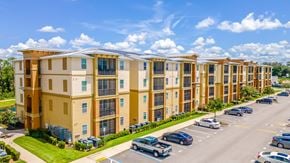 Lady Lake apartment for rent - A row of apartment buildings with cars parked in front.