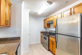 Palm Coast apartment for rent - a kitchen with stainless steel appliances and wooden cabinets