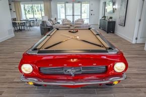 Palm Coast apartment for rent - A red vintage car is parked in a room with a pool table.