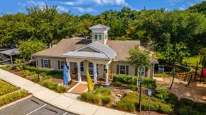 Lady Lake apartment for rent - an aerial view of a house with a playground and trees