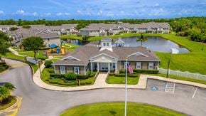 Port St. Lucie apartment for rent - A residential area with a house in the foreground and a playground in the background.