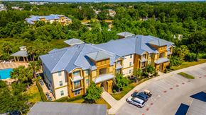 Seffner apartment for rent - A large building with a pool in front of it.