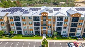 Orange City apartment for rent - a large apartment building with solar panels on the roof