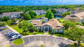 Kissimmee apartment for rent - A bird's eye view of an apartment complex, a parking lot, and a playground.