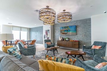 Daytona Beach apartment for rent - a living room with a gray couch and chairs and a table