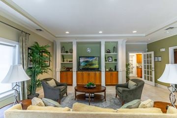 Deland apartment for rent - a living room with a couch and chairs and a television