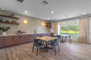Palm Coast apartment for rent - A kitchen with a table and chairs in front of a window.