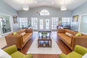 Winter Garden apartment for rent - A living room with a brown couch and green chairs.