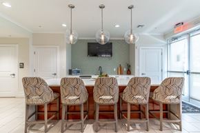 Lady Lake apartment for rent - A kitchen with a row of chairs in front of a counter.