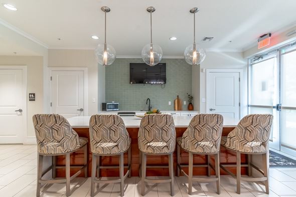 Lady Lake apartment for rent - A kitchen with a row of chairs in front of a counter.