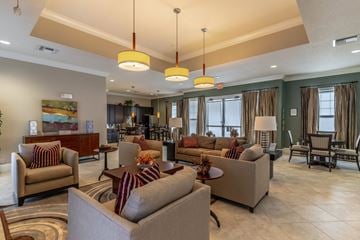 Winter Park apartment for rent - A living room with a large couch and a painting on the wall.