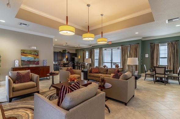Winter Park apartment for rent - A living room with a large couch and a painting on the wall.